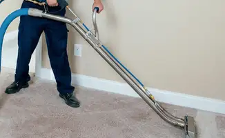 Professional operating a liquid removal machine on a carpeted floor in Tacoma, WA